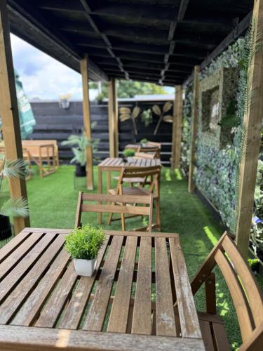 a wooden table with a potted plant on a patio at The Glendevon Hotel in Auchterarder
