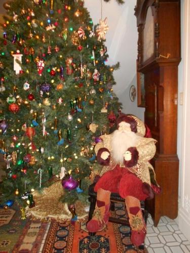 a christmas tree with a teddy bear in front of it at House of 1833 Bed and Breakfast in Mystic