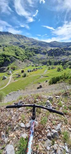 a bike parked on the side of a hill at Katun Mokra accommodation & horseback riding in Podgorica