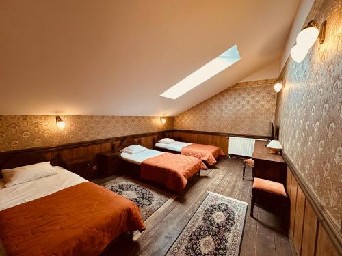 a bedroom with two beds and a skylight at St. Peterburg in Pärnu