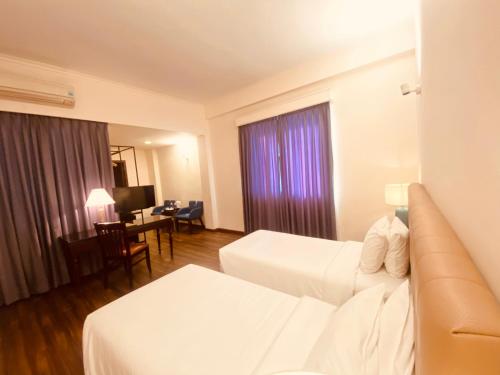Katil atau katil-katil dalam bilik di Liberty 2 Hotel