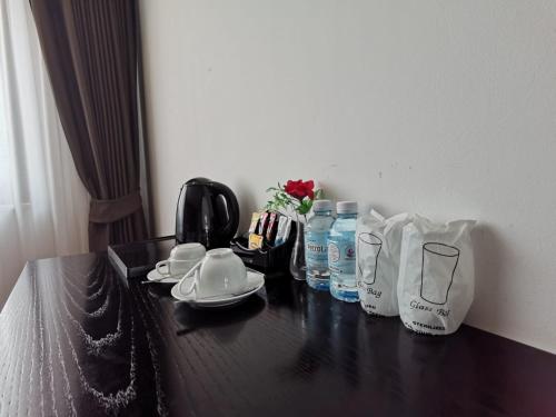 a table with bottles of water and other items on it at Aaron Hotel in Vientiane