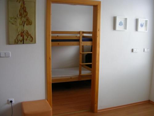 a door into a room with a bunk bed at Holiday Home Lipno Frymburk in Frymburk