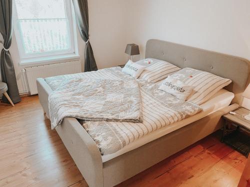 a bed with two pillows and a blanket on it at Ferienwohnung Nr 6 in Hinrichsdorf