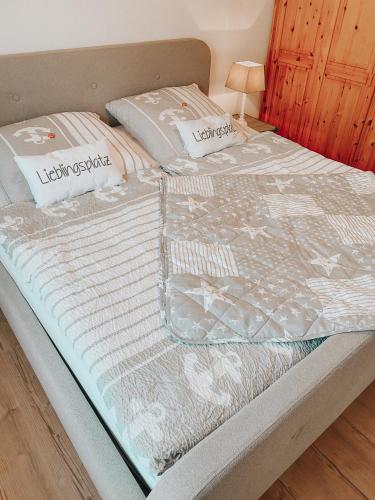 a bed with two pillows on top of it at Ferienwohnung Nr 6 in Hinrichsdorf