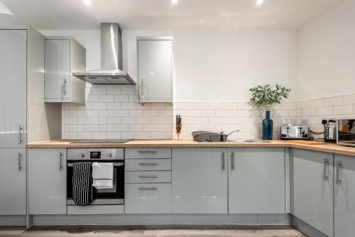a kitchen with white cabinets and a counter top at Lovely 1 Bedroom Apartment in Central Rotherham in Rotherham