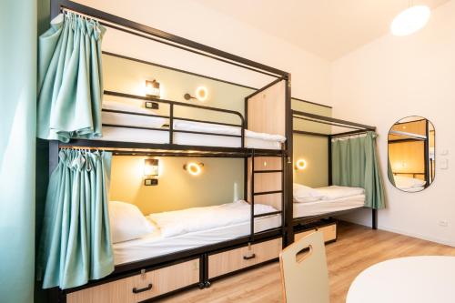 a room with bunk beds in a hostel at Luma Terra Prague Hostel in Prague