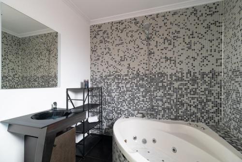 a bathroom with a bath tub and a sink at La Casita de Alcabre in Vigo