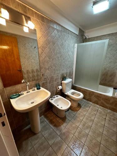 a bathroom with a sink and a toilet at Lugones House in Cordoba