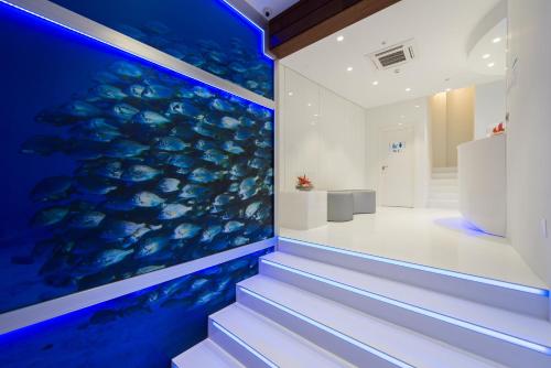 a staircase with a large aquarium in a room at Wavia Hotel - Adults only in Las Palmas de Gran Canaria