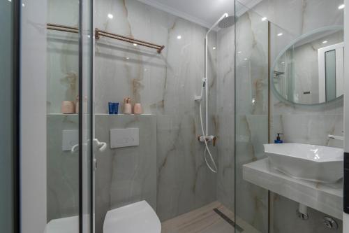 a bathroom with a shower and a toilet and a sink at Paradise in Nea Vrasna