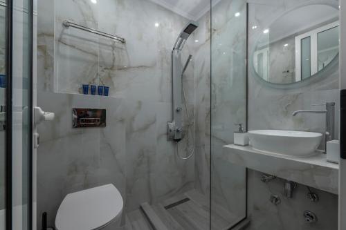 a bathroom with a shower and a toilet and a sink at Paradise in Nea Vrasna