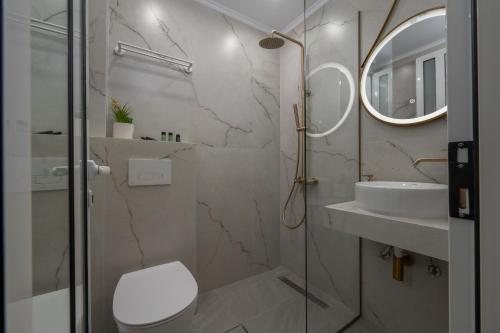 a bathroom with a shower and a toilet and a sink at Paradise in Nea Vrasna