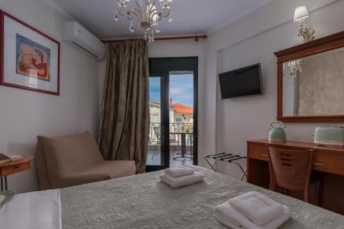 a room with a table and a chair and a desk at Paradise in Nea Vrasna
