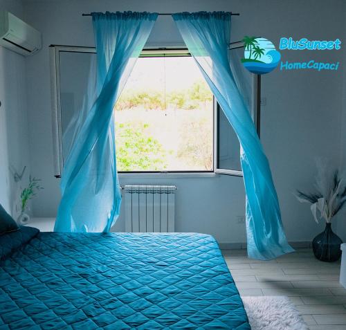 Una cama o camas en una habitación de BluSunset Home Capaci