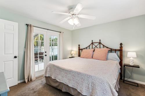 a bedroom with a bed and a ceiling fan at Charming Heated Pool Home - 3 miles to the Beach, Pet and Family Friendly -Available Year Round! in Bonita Springs