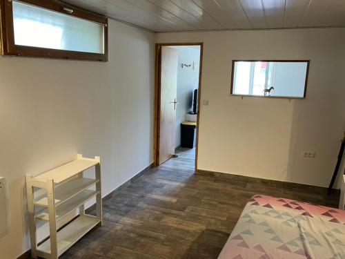 a room with a bed and a window and a door at appartement deux pieces in Notre-Dame-de-Londres
