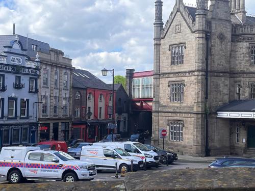 a group of cars parked in a parking lot next to a building at Tumbledown Hotel in Shrewsbury
