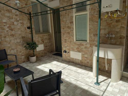 a bathroom with a shower with a sink and a table at Le tre coccinelle in Porto Cesareo