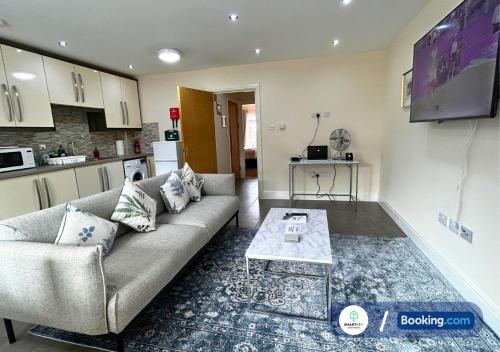 a living room with a couch and a table at Modern 2 Bed 2 Bath Apartment Free Parking in Watford