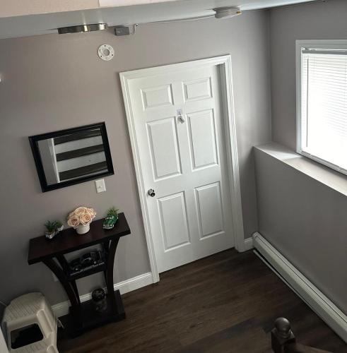 a room with a door and a table and a window at Basement room with its own private bathroom in Providence