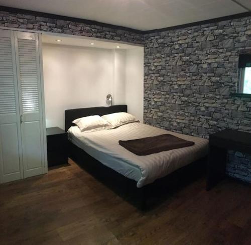 a bedroom with a bed and a brick wall at Villa a Hovås con molti comfort in Hovås