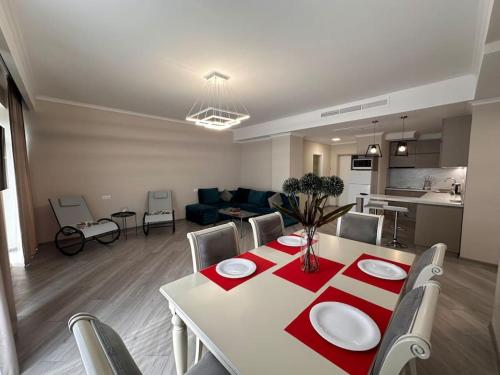 a living room with a dining table and a kitchen at Apt with Terrace to chill and Mountain View in Tsaghkadzor