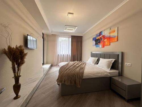 a bedroom with a bed and a vase in it at Apt with Terrace to chill and Mountain View in Tsaghkadzor