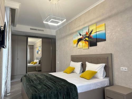 a bedroom with a large bed with yellow pillows at Apt with Terrace to chill and Mountain View in Tsaghkadzor