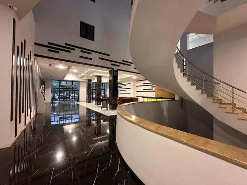 a lobby with a spiral staircase in a building at Apt with Terrace to chill and Mountain View in Tsaghkadzor