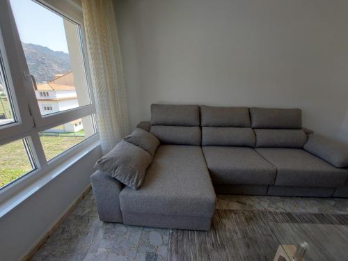 a couch sitting in a room next to a window at Bahia de Ezaro, Costa da Morte in Dumbría