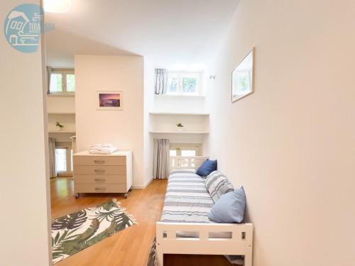 a living room with a couch in the corner at Cattedrale 5 Tirabora Short Rent in Trieste