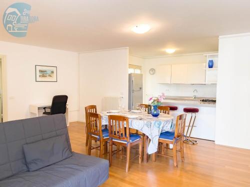 a kitchen and dining room with a table and chairs at Cattedrale 5 Tirabora Short Rent in Trieste