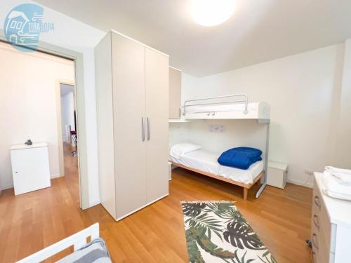 a small room with a bunk bed and a white cabinet at Cattedrale 5 Tirabora Short Rent in Trieste