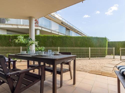 a patio with a table and chairs and a building at Apartment Viena 3 by Interhome in L'Ampolla