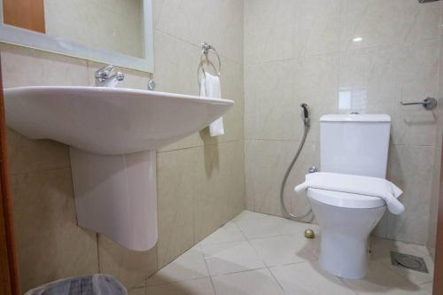 a bathroom with a sink and a toilet at Ideal for Families Close to ALL Amenities in Dubai