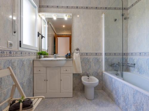 a bathroom with a sink and a toilet and a mirror at Villa Imma by Interhome in L'Eucaliptus