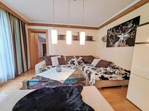 a living room with a couch and a table at Apartment Kröll beim Geislerhof by Interhome in Ramsau