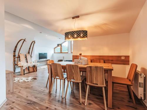 a dining room with a table and chairs at Apartment Hoamat by Interhome in Goldegg