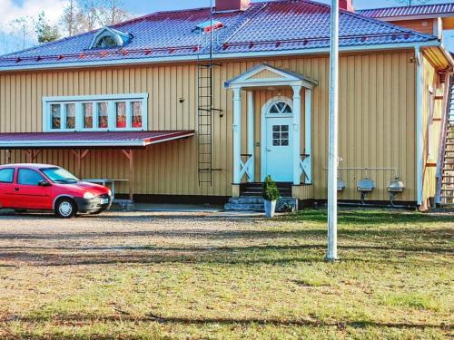 a house with a red car parked in front of it at Holiday Home Kaislajärven huvila by Interhome in Risulahti