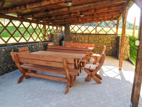 a wooden table and chairs in a pavilion at Holiday Home Jílové by Interhome in Jílové