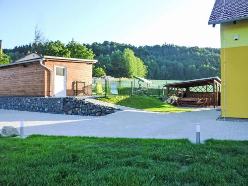 a park with a building and a pavilion and a playground at Holiday Home Jílové by Interhome in Jílové