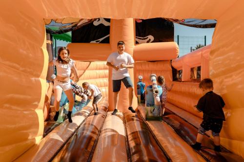 a group of people on a ride at an amusement park at Club Hotel Aguamarina in Arenal d'en Castell