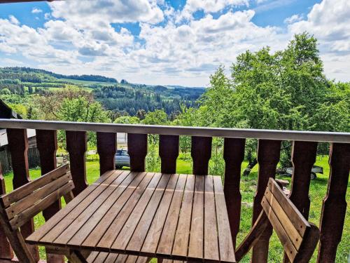a wooden bench on a balcony with a view at Holiday Home Jizerka by Interhome in Tanvald