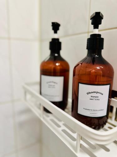 two bottles of soap are sitting on a shelf at Massive Karli Loft - over 130 meters floor space - home theater room - 4 private sleeping areas - best location in Leipzig in Leipzig