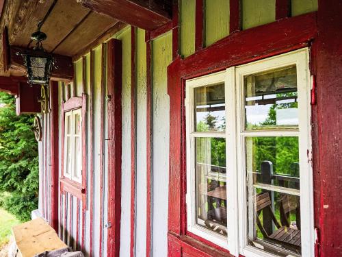 a red door and windows on a house at Holiday Home Jizerka by Interhome in Tanvald