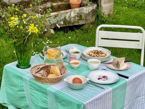 a blue table with bread and other food on it at Le manoir de Jasmine in Chabrignac