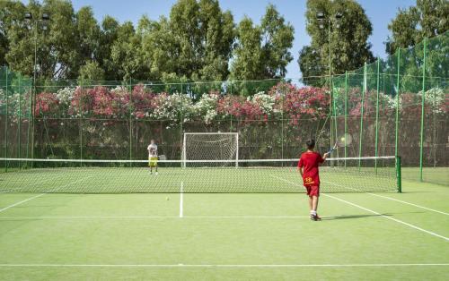 two people playing tennis on a tennis court at Sentido Orosei Beach in Orosei