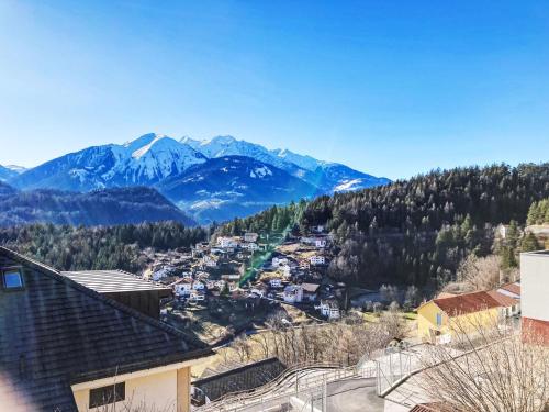 a view of a town with mountains in the background at Apartment Panorama da muntognas by Interhome in Trin