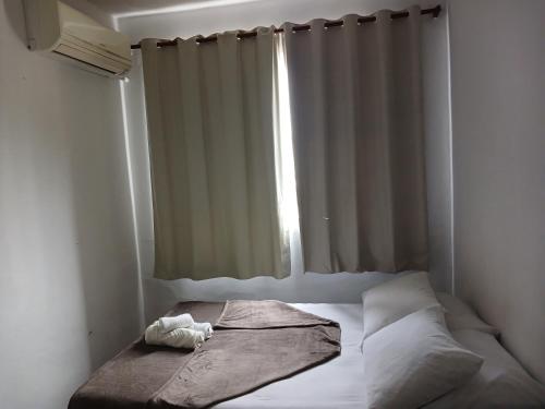 a bed in a room with a window at Acacia hotel in Laguna